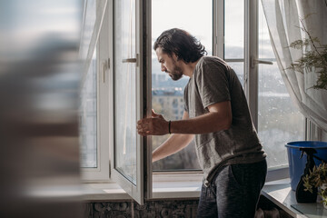 A man washes windows at home