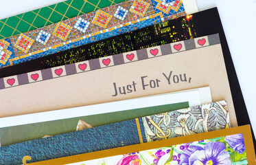 pile of greeting cards with the words: Just For You at the centre 