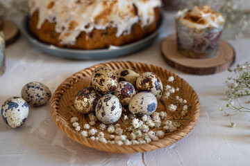 Quail eggs in a wicker plate, цhite flowers, making muffins