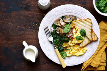 Omelet  with spinach , mushrooms and cheese . Top view with copy space.