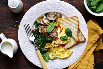 Omelet  with spinach , mushrooms and cheese . Top view with copy space.