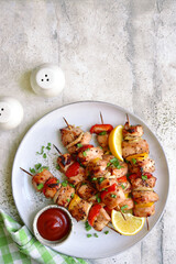 Chicken kebab skewers on a plate . Top view with copy space.