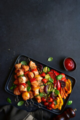 Chicken skewers kebab with grilled vegetables. Top view with copy space.