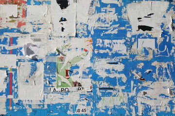 Naklejka premium Old Billboard with Torn Posters. Dirty Street Wall with Crumpled, Wrinkled, Creased, Worn and Torn Posters. Abstract Vintage Background and Texture.