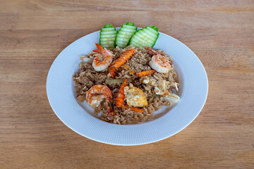A top-down view of Thai food with a wood background. Bamboo shoots, Glass noodles, Carrot, Oyster sauce, Rice, shrimp, Cabbage, onions, strong basil, 