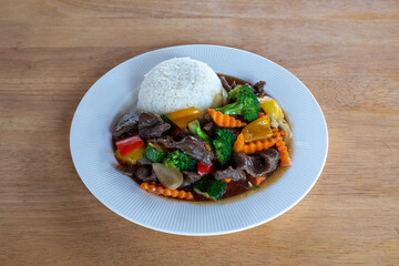 A top-down view of Thai food with a wood background. Bamboo shoots, Glass noodles, Carrot, Oyster sauce, Rice, shrimp, Cabbage, onions, strong basil, 