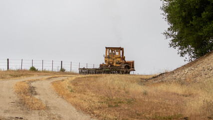 Fototapeta premium Bull Dozer on California Farmlands