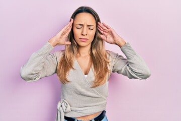 Beautiful hispanic woman wearing casual sweater with hand on head, headache because stress. suffering migraine.