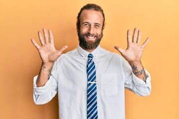 Handsome man with beard and long hair wearing business clothes showing and pointing up with fingers number ten while smiling confident and happy.