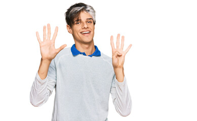 Young hispanic man wearing casual clothes showing and pointing up with fingers number nine while...