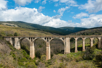 Fototapeta na wymiar Ancient railway track bridge landscape. Horizontal aerial photography with drone. Concept of life, destiny or direction to follow, thought, reflection, meditation. Selective focus