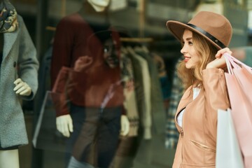 Young blonde girl shopping looking showcase shop.