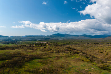 Rural landscape with spectacular mountains in the background. Horizontal aerial photography with drone. Concept of life, vacation, fun and adventure. Selective focus