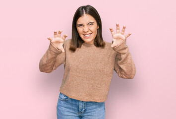 Young beautiful woman wearing casual clothes smiling funny doing claw gesture as cat, aggressive...