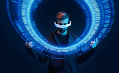 Man on dark virtual reality background. Guy using VR helmet. Augmented reality, future technology, game concept. Blue neon light. Futuristic holographic interface to display data.