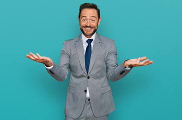 Middle age man wearing business clothes smiling cheerful offering hands giving assistance and acceptance.