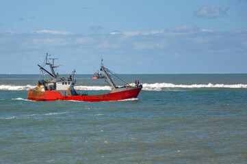 Red fishing boat on the sea