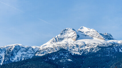 panorama of mountains with snow on top clear blue sky British Columbia Canada
