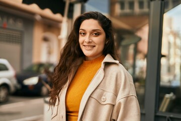 Young middle east woman smiling happy standing at the city.