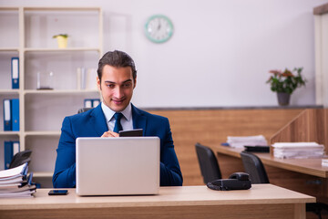 Young male employee working in the office