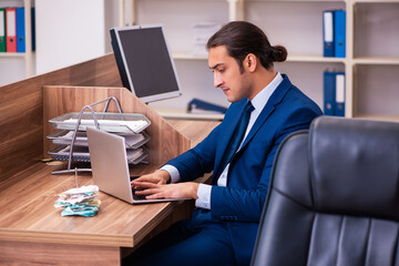 Young male employee working in the office