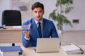 Young male employee sitting in the office