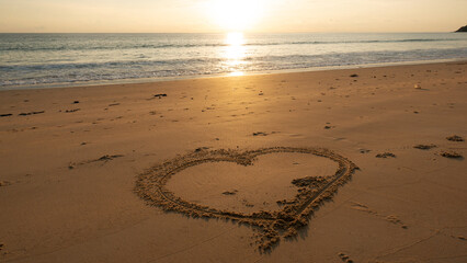 Heart symbol on beach, Hand drawn heart on beach sand over sunset or sunrise sky beautiful light nature landscape