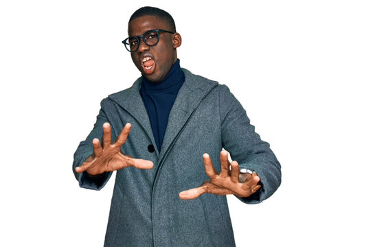 Young african american man wearing business clothes and glasses afraid and terrified with fear expression stop gesture with hands, shouting in shock. panic concept.