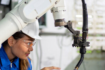 Engineer check and control welding robotics automatic arms machine in intelligent factory industrial.