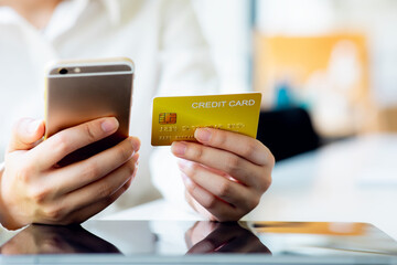 Close up woman hand using credit card and tablet for buying online shopping at home ,payment,buying and online shopping concept.