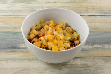 Freshly cooked warm potato and red pepper salad with melted cheese