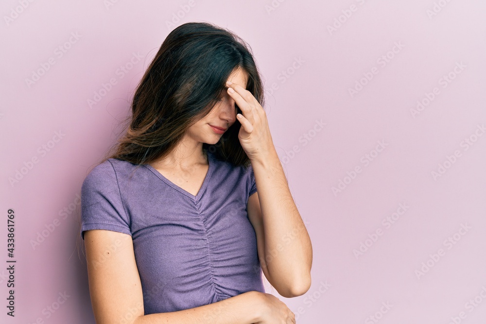 Poster young caucasian woman wearing casual clothes tired rubbing nose and eyes feeling fatigue and headach