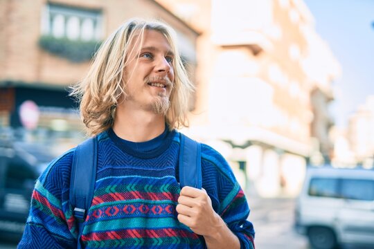 Young scandinavian student man smiling happy standing at the city.