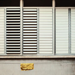 yellow wet rag hanging outside the window on a rope 
