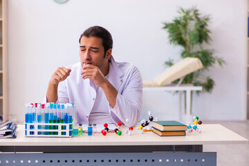 Fototapeta premium Young male chemist working in the lab