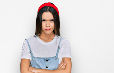 Young hispanic girl wearing casual clothes skeptic and nervous, disapproving expression on face...