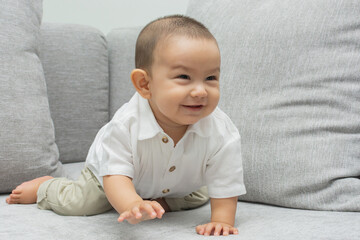 Fototapeta premium Smiling beautiful baby on armchair.