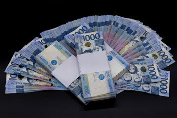 A pile of one thousand Philippines peso banknotes. Cash of Thousand dollar bills, Peso background...