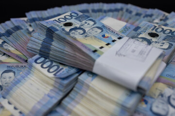 A pile of one thousand Philippines peso banknotes. Cash of Thousand dollar bills, Peso background...
