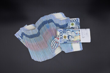 A pile of one thousand Philippines peso banknotes. Cash of Thousand dollar bills, Peso background...