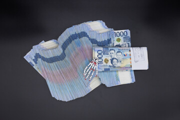 A pile of one thousand Philippines peso banknotes. Cash of Thousand dollar bills, Peso background image.