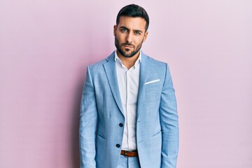Young hispanic businessman wearing business jacket skeptic and nervous, frowning upset because of problem. negative person.