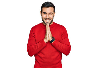 Young hispanic man wearing casual clothes praying with hands together asking for forgiveness smiling confident.