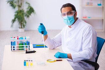 Young male chemist working in the lab