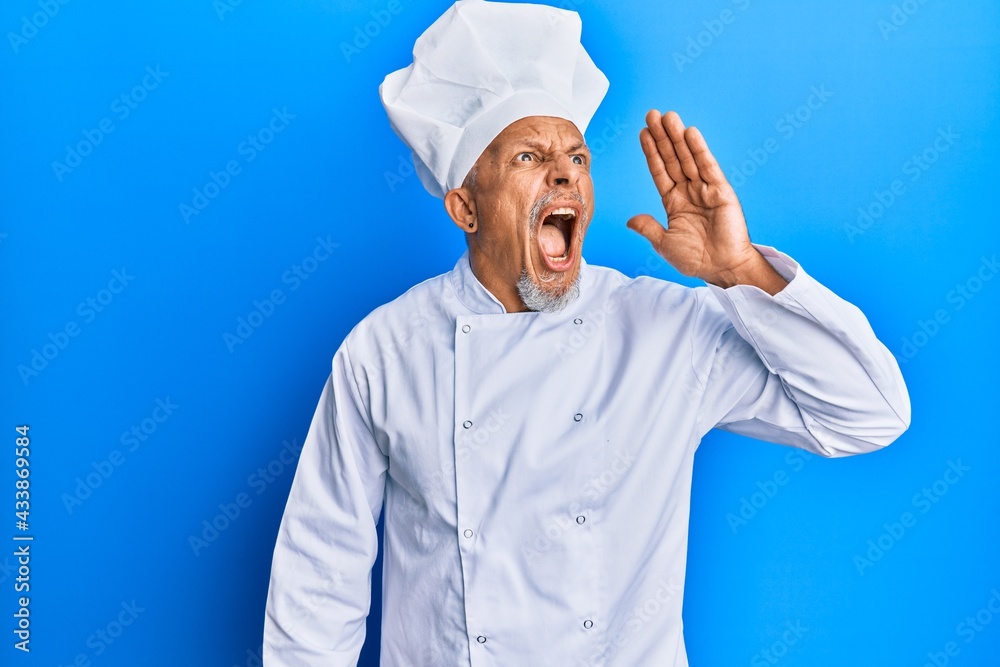 Canvas Prints Middle age grey-haired man wearing professional cook uniform and hat shouting and screaming loud to side with hand on mouth. communication concept.