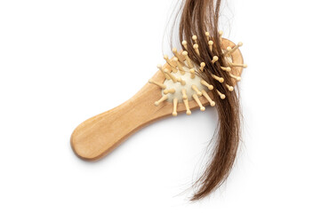 Wooden comb with lock of hair on white background.