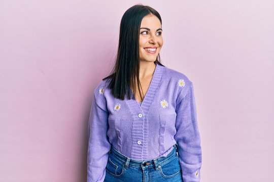 Young Brunette Woman Wearing Spring Cardigan With Flowers Print Looking To Side, Relax Profile Pose With Natural Face And Confident Smile.