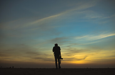 silhouette of a person standing on salt dessert
