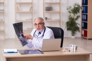 Experienced male doctor radiologist working in the clinic