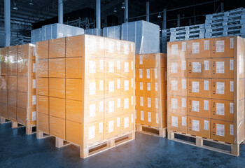 Interior of Storage Warehouse. Stacked of Package Boxes Wrapped Plastic Flim on pallet rack. L-Shape Pallet Corrugated Paper Cardboard Angle Corner Edge Protector. Shipping Warehouse Logistics.